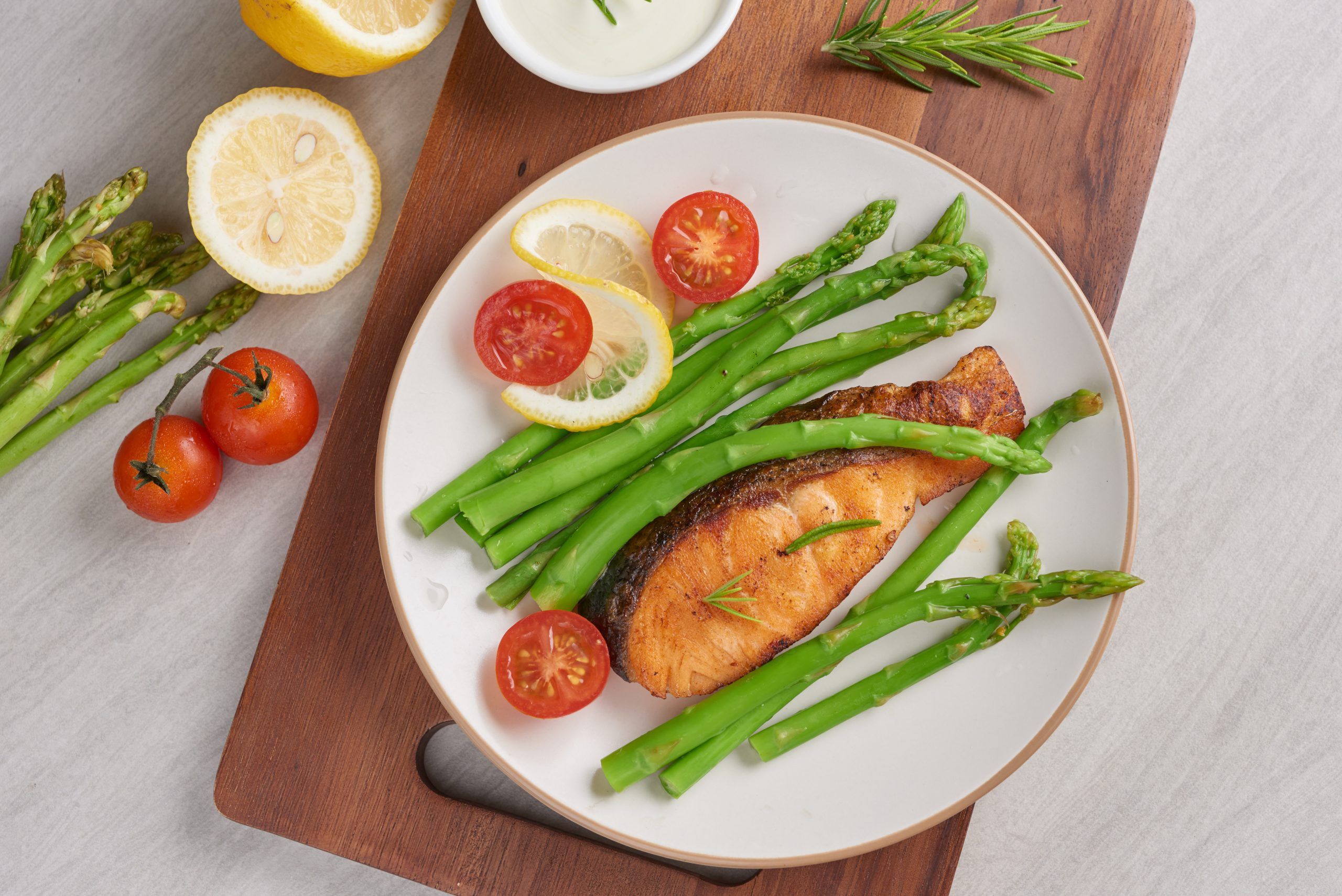 Delicious seasonal green asparagus and sliced smoked salmon on a