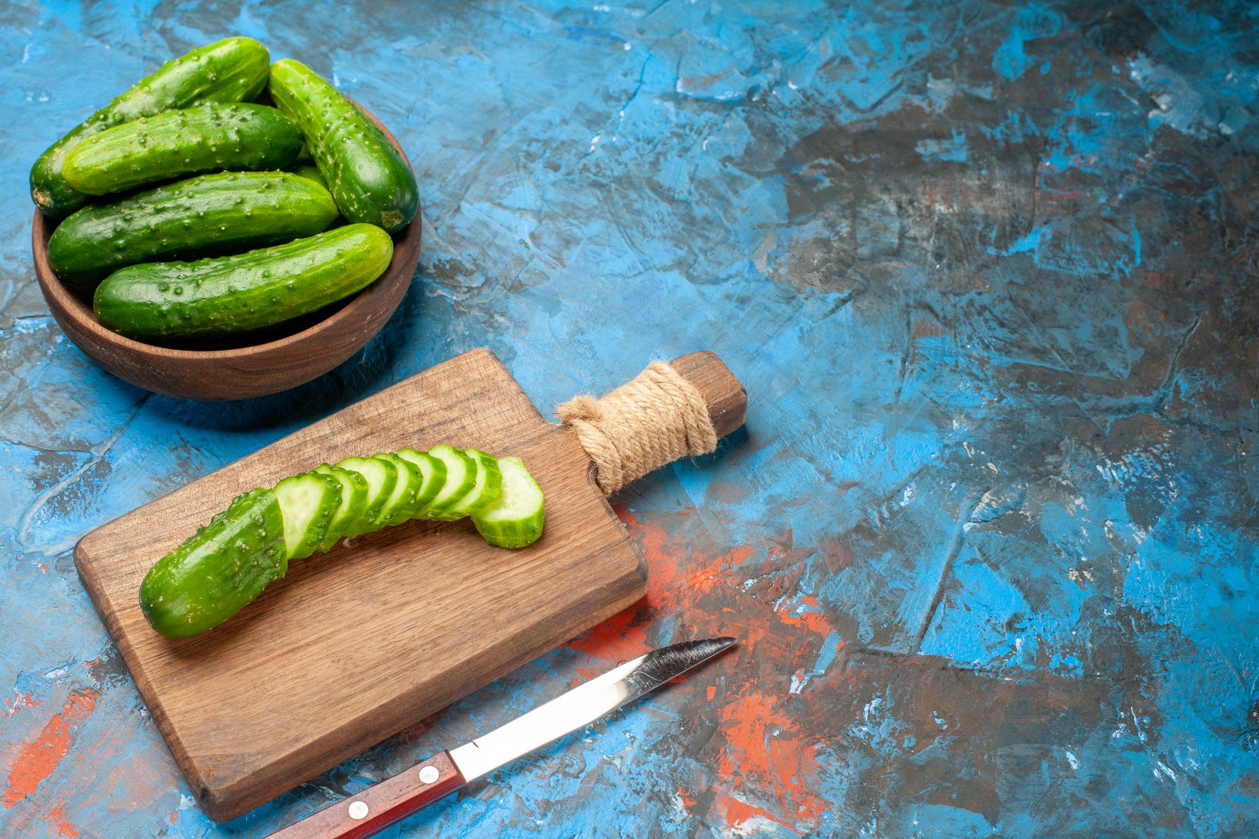 front-view-fresh-green-cucumbers-inside-plate-on-blue-background-meal-salad-health-photo-ripe-food-diet-color